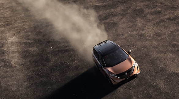 2023 Nissan Ariya seen from above driving through a dust plain