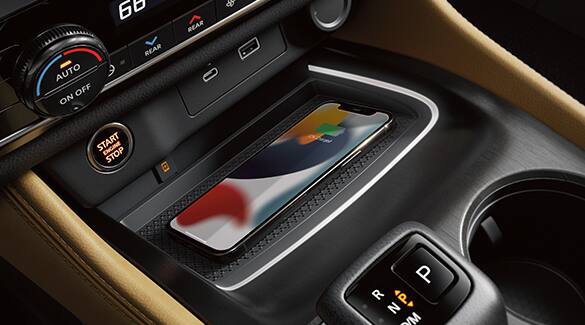 2023 Nissan Rogue showing smartphone on wireless charging pad.