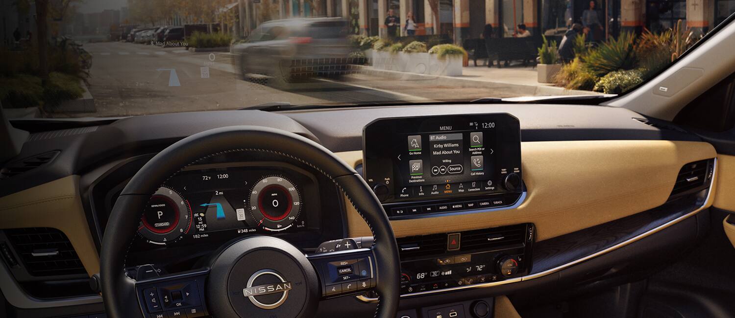 2023 Nissan Rogue showing gauge cluster and touch-screen display.